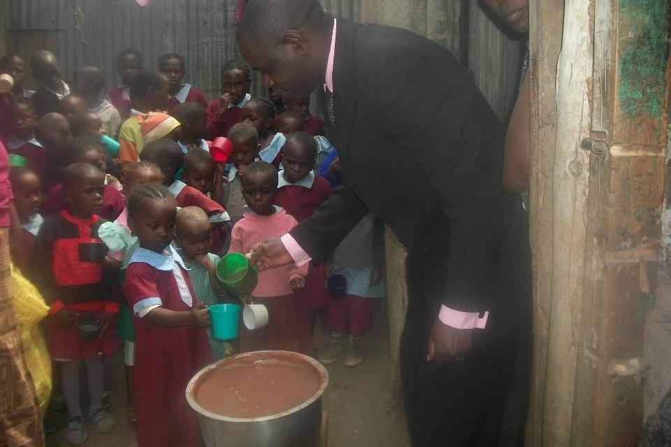 Apostle Benson serving the slum children 